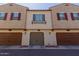 Townhome featuring a private garage with decorative shutters adding charm at 2660 S Equestrian Dr # 103, Gilbert, AZ 85295