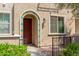 Charming front entrance with an arched doorway, colorful accents, and manicured greenery at 2660 S Equestrian Dr # 103, Gilbert, AZ 85295