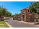 A brick gate house in a private community with mature trees and landscaping at 2660 S Equestrian Dr # 103, Gilbert, AZ 85295