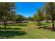 Community green space and walking path between buildings with mature trees at 2660 S Equestrian Dr # 103, Gilbert, AZ 85295