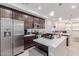 Well-lit kitchen with stainless steel appliances, a center island, and a view into the living space at 2660 S Equestrian Dr # 103, Gilbert, AZ 85295