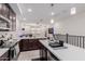 Open-concept kitchen with a breakfast bar, stainless steel appliances, and seamless transition to the living area at 2660 S Equestrian Dr # 103, Gilbert, AZ 85295