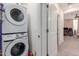 Bright laundry room with a stackable washer and dryer for space saving convenience at 2660 S Equestrian Dr # 103, Gilbert, AZ 85295