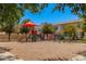 Community playground and jungle gym with colorful equipment and shade canopy at 2660 S Equestrian Dr # 103, Gilbert, AZ 85295