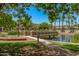 Picturesque community pond with bridge and lush landscaping offers a serene escape for residents at 2660 S Equestrian Dr # 103, Gilbert, AZ 85295