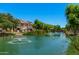 Picturesque pond with fountains and residential buildings shows the luxurious community and serene ambiance at 2660 S Equestrian Dr # 103, Gilbert, AZ 85295