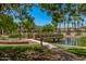 Picturesque community pond with bridge and lush landscaping offers a serene escape for residents at 2660 S Equestrian Dr # 103, Gilbert, AZ 85295