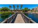 Scenic pond view with walking bridge and cabana shows luxurious community and serene ambiance at 2660 S Equestrian Dr # 103, Gilbert, AZ 85295