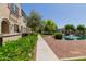 Sidewalk view of a community pond with a small bridge and townhome buildings at 2660 S Equestrian Dr # 103, Gilbert, AZ 85295
