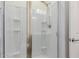 Bright bathroom with a glass-door shower and white-tiled walls at 2660 S Equestrian Dr # 103, Gilbert, AZ 85295