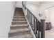 Carpeted staircase with gray railing, leading to upper floors and a light-filled home at 2660 S Equestrian Dr # 103, Gilbert, AZ 85295
