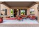 Back porch with sliding glass doors, patio furniture, and desert views at 26853 N 89Th Dr, Peoria, AZ 85383