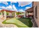 Lush backyard featuring a putting green, spa, and BBQ, designed for entertaining and relaxation at 26853 N 89Th Dr, Peoria, AZ 85383