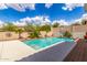 Refreshing backyard pool with lush landscaping and blue skies, great for relaxation at 26853 N 89Th Dr, Peoria, AZ 85383
