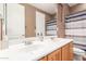Well-lit bathroom featuring double sinks with wood cabinets and a shower/tub combo at 26853 N 89Th Dr, Peoria, AZ 85383