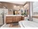Beautiful bathroom features a soaking tub, walk-in shower, vanities with wood cabinets, and neutral earth-tone color scheme at 26853 N 89Th Dr, Peoria, AZ 85383