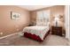Inviting bedroom with a comfortable bed, window with shutters, side tables, and neutral-toned walls at 26853 N 89Th Dr, Peoria, AZ 85383