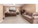 Spacious bedroom with a large bed, sofa, dresser, and ceiling fan at 26853 N 89Th Dr, Peoria, AZ 85383