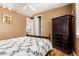 Comfortable bedroom with hardwood floors, wooden cabinet, and a window with natural light at 26853 N 89Th Dr, Peoria, AZ 85383