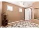 Neutral bedroom featuring a decorative rug, wooden floors, and window shutters at 26853 N 89Th Dr, Peoria, AZ 85383