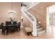 Expansive dining area featuring high ceilings, tile flooring, a staircase, and a modern chandelier at 26853 N 89Th Dr, Peoria, AZ 85383