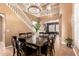 Spacious dining area with a chandelier and staircase in an open-concept living space at 26853 N 89Th Dr, Peoria, AZ 85383