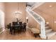 Spacious dining area with a staircase, high ceilings, and tile flooring, complete with elegant chandelier at 26853 N 89Th Dr, Peoria, AZ 85383