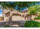 Expansive two-story home boasting multiple garage spaces and a nicely landscaped front yard with mature trees at 26853 N 89Th Dr, Peoria, AZ 85383