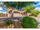 Spacious two-story home with multiple garage spaces, complemented by well-kept landscaping and a paved driveway at 26853 N 89Th Dr, Peoria, AZ 85383