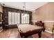 Game room with a pool table, tile floors, accent wall, and light fixtures at 26853 N 89Th Dr, Peoria, AZ 85383