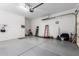 Clean garage with painted floors, white walls, and ample storage space at 26853 N 89Th Dr, Peoria, AZ 85383