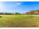 Expansive grassy community space with picnic area and playground in the distance at 26853 N 89Th Dr, Peoria, AZ 85383