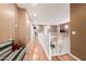 Upstairs hallway boasts wood floors, white railing, lots of light, and neutral walls at 26853 N 89Th Dr, Peoria, AZ 85383