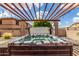 Private backyard hot tub under a modern pergola, set for relaxation and outdoor enjoyment at 26853 N 89Th Dr, Peoria, AZ 85383