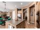 Open kitchen featuring a large island with wood cabinets, stainless steel appliances, and neutral earth-tone color scheme at 26853 N 89Th Dr, Peoria, AZ 85383