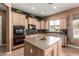 Kitchen with an island, stainless steel appliances, and a window with natural light at 26853 N 89Th Dr, Peoria, AZ 85383