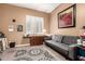 Charming living room with a comfortable couch, decorative rug, and natural light from the window at 26853 N 89Th Dr, Peoria, AZ 85383