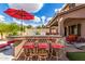 Outdoor bar area with a red umbrella and seating at 26853 N 89Th Dr, Peoria, AZ 85383