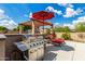 Outdoor grill with bar and lounge chairs at 26853 N 89Th Dr, Peoria, AZ 85383