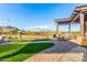 Community patio with pergola, seating, outdoor kitchen, and mountain views at 26853 N 89Th Dr, Peoria, AZ 85383