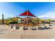 Community playground featuring shade canopies, play structures, seating, and desert landscaping at 26853 N 89Th Dr, Peoria, AZ 85383
