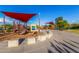 Community playground with shade canopies, play structures, seating, and mature landscaping at 26853 N 89Th Dr, Peoria, AZ 85383