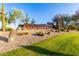 A community entrance with decorative rocks, cacti and a welcoming sign set amidst desert landscaping at 26853 N 89Th Dr, Peoria, AZ 85383