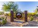 A rustic sign welcomes visitors to the community, surrounded by desert plants and greenery at 26853 N 89Th Dr, Peoria, AZ 85383