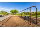 Community swingset with wood chip base, landscaping, and paved walkway at 26853 N 89Th Dr, Peoria, AZ 85383