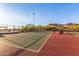 Community tennis court with mountain views, shade structure, and perimeter fencing at 26853 N 89Th Dr, Peoria, AZ 85383