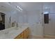 Accessible bathroom with double sink vanity, walk-in tub, and glass shower enclosure at 287 W Liberty Ln, Gilbert, AZ 85233