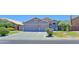 Beautiful single Gathering home with mature landscaping and a large driveway leading to a three-car garage at 287 W Liberty Ln, Gilbert, AZ 85233