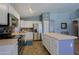 Bright, open kitchen featuring stainless steel appliances, white cabinets, and an island at 287 W Liberty Ln, Gilbert, AZ 85233