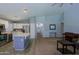 Open living space with kitchen, carpeted living room, and natural light at 287 W Liberty Ln, Gilbert, AZ 85233